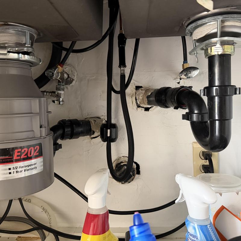 Kitchen sink drain pipes and garbage disposal setup