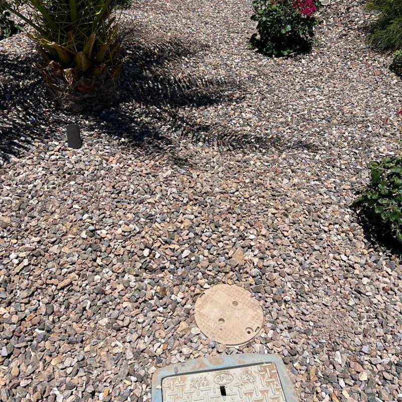 Pressure regulating valve with valve cover in gravel bed
