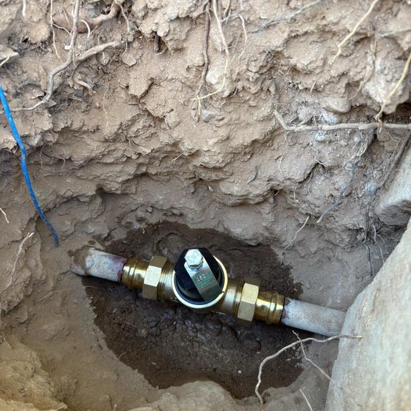 Pressure relief valve installed in ground near curb stop