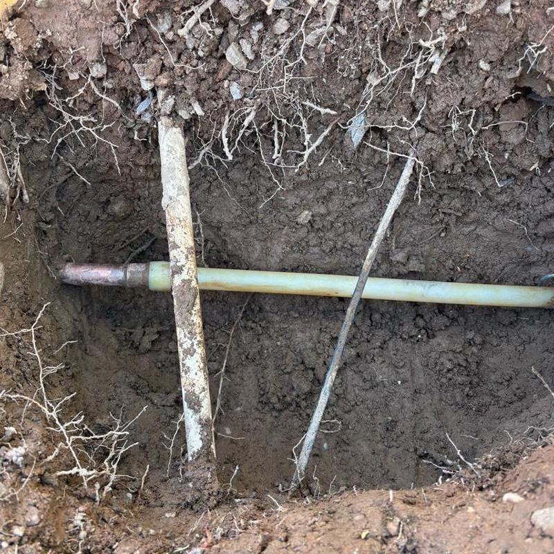 Main water line with ball valve installation in dirt hole