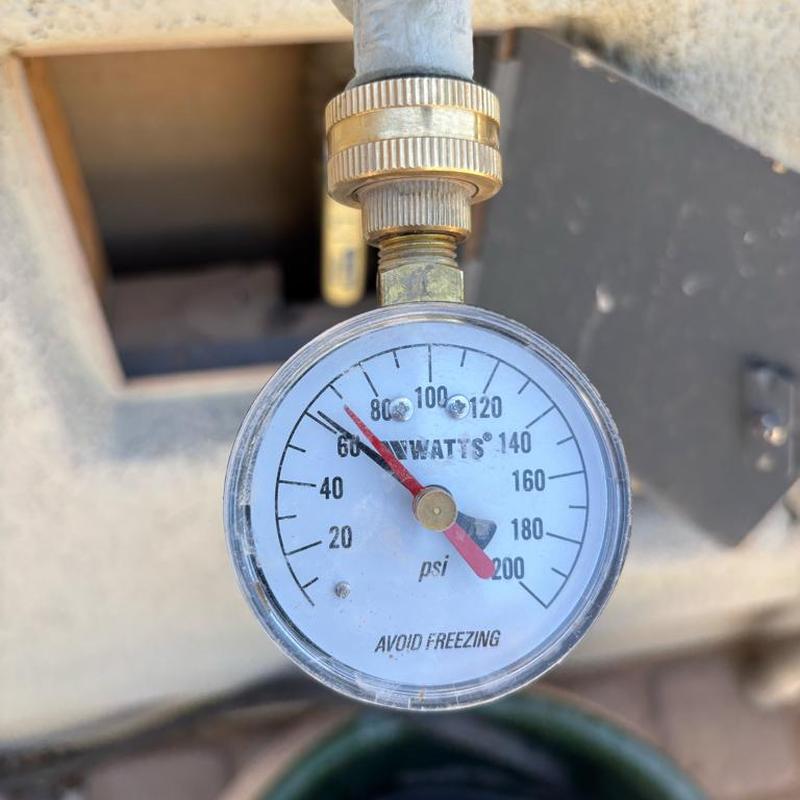 Water pressure gauge on main line near curb stop box