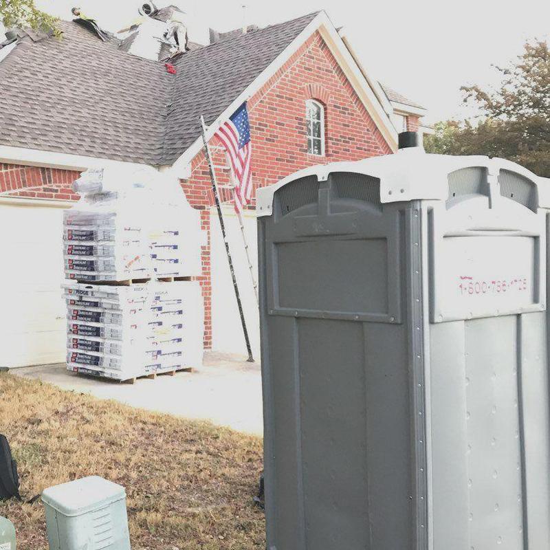 Roof shingles and gutters replacement with workers on roof