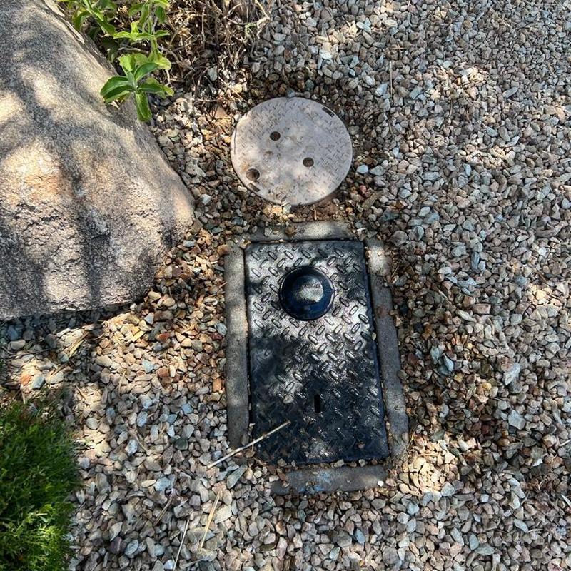 Pressure regulating valve box in gravel landscaping