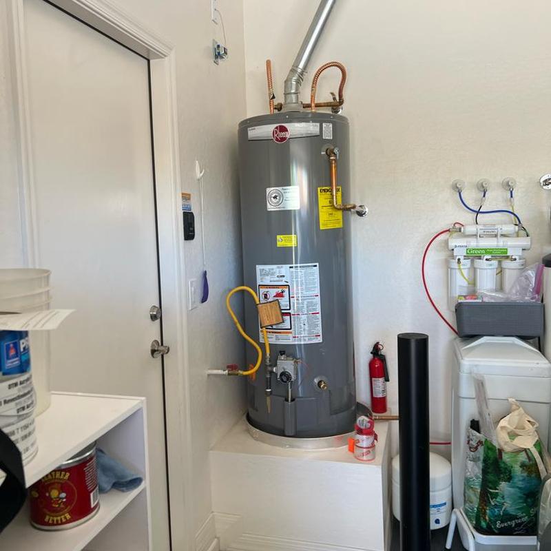 Water heater flushing and sediment removal in utility room