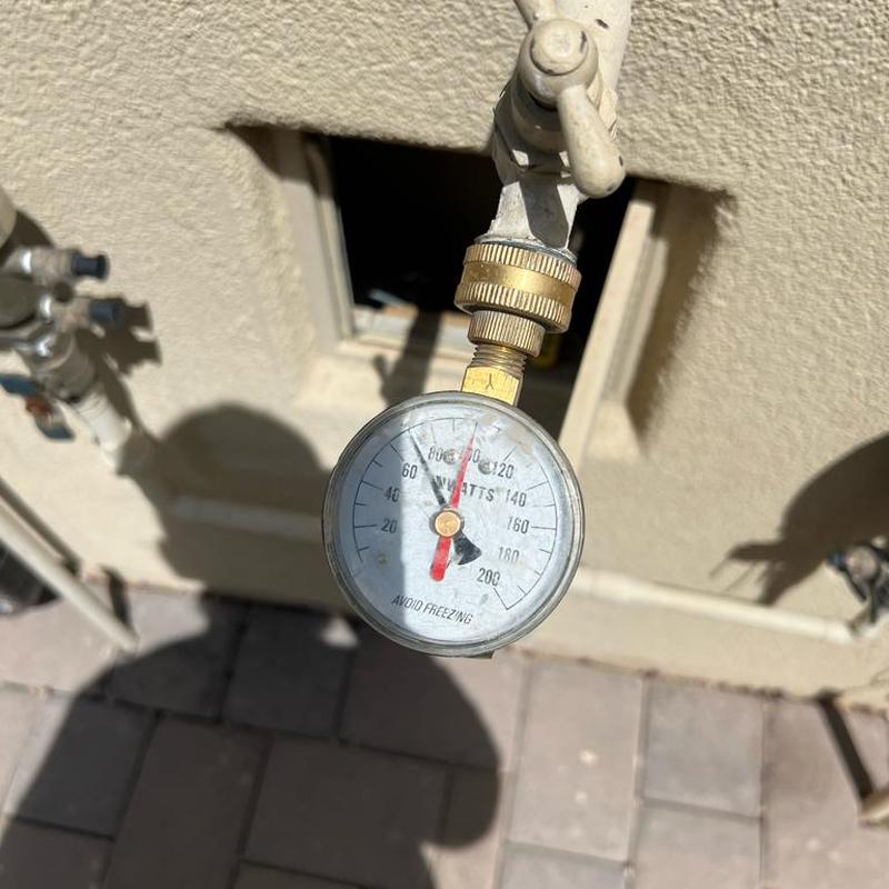 Pressure regulator valve gauge on plumbing line