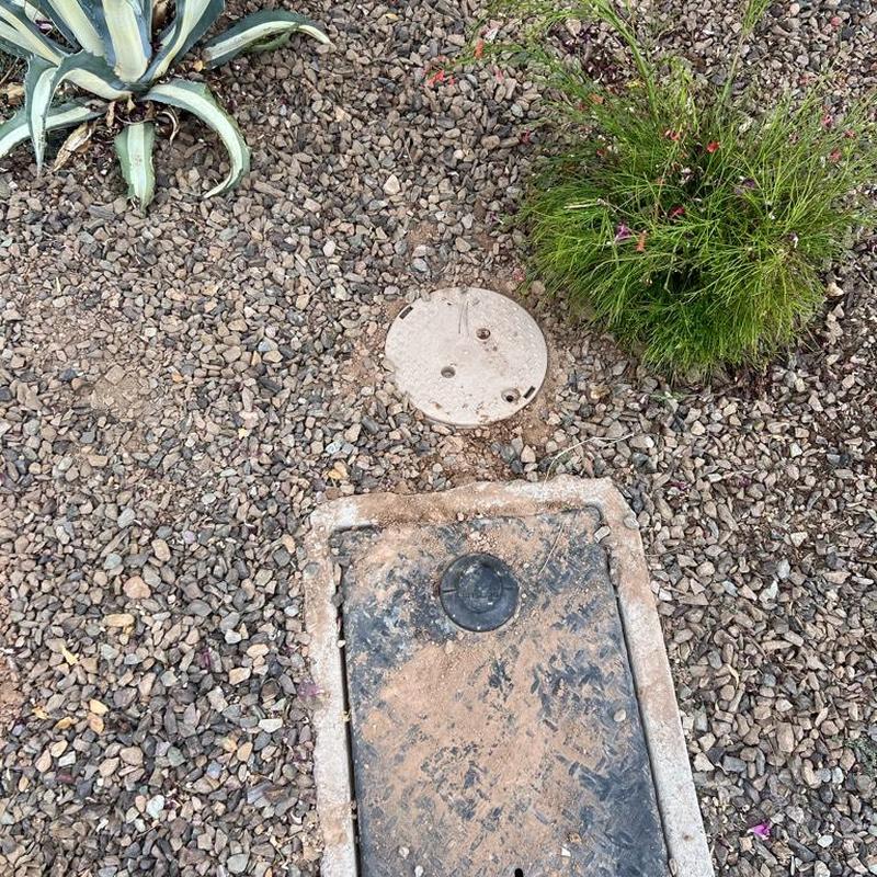 Pressure regulator valve access box and landscaping in gravel