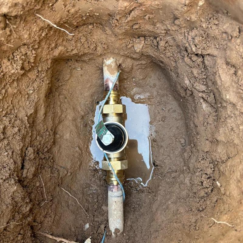 Pressure relief valve installation with tan access box in dirt