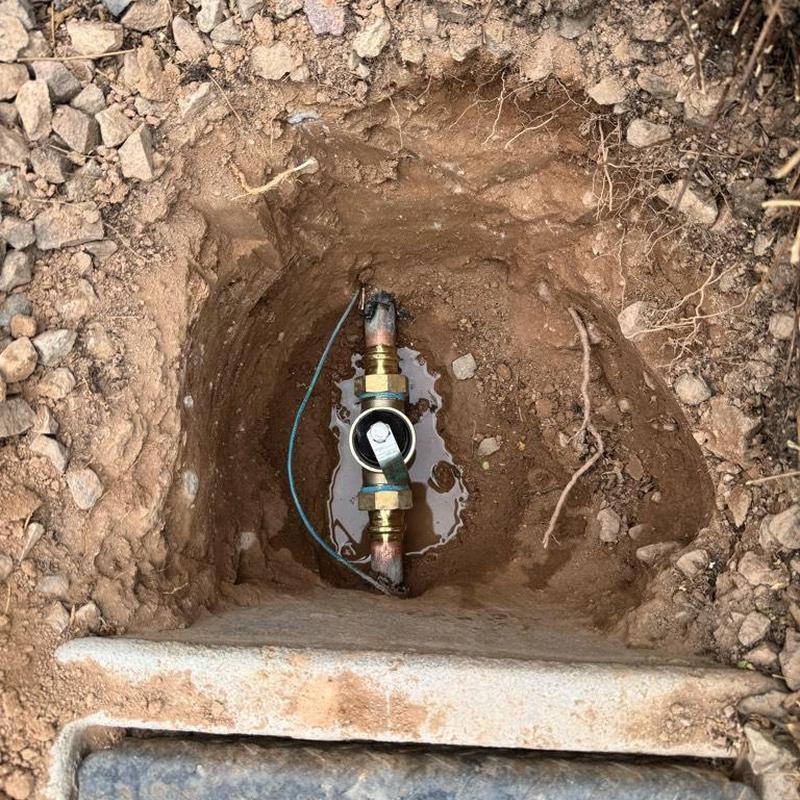 Water main pressure regulator valve installed in soil hole