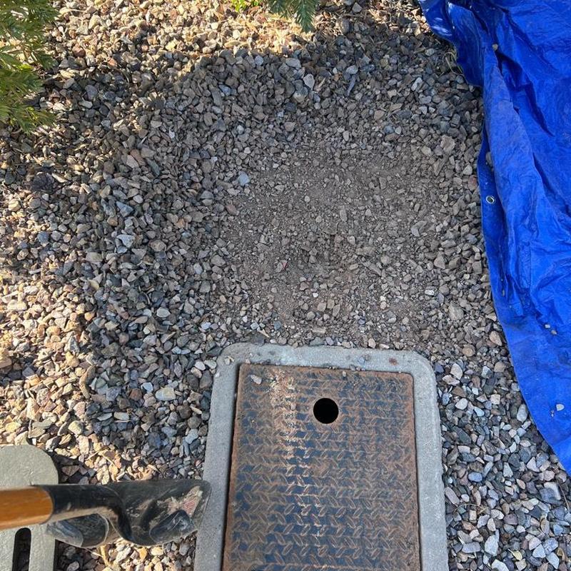 Pressure reducing valve in landscape valve box with gravel area.