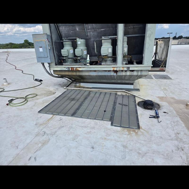 Commercial rooftop HVAC unit with access panels open Commercial rooftop HVAC unit with access panels open