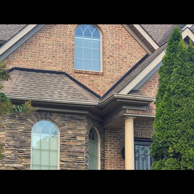 Roof shingles and gutters on brick home exterior Roof shingles and gutters on brick home exterior