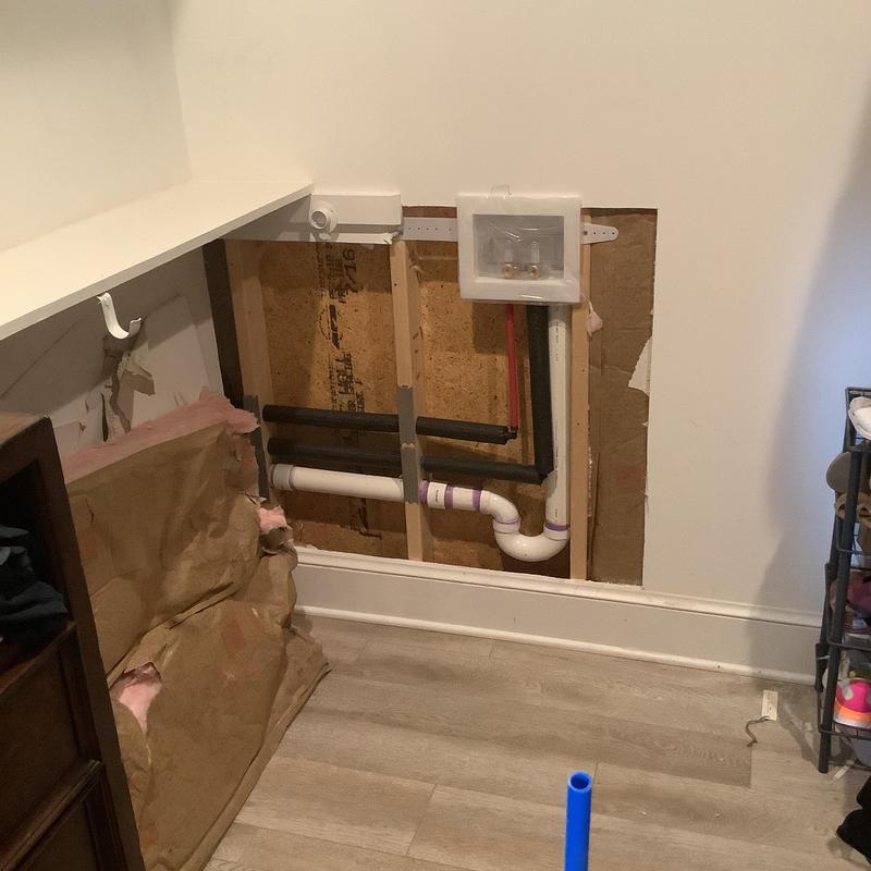 Washing machine box with relocated plumbing pipes Washing machine box with relocated plumbing pipes