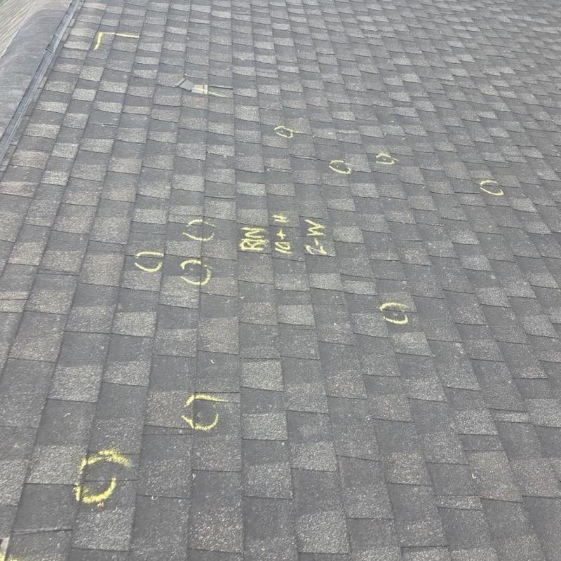 Shingle roof hail damage marked for inspection