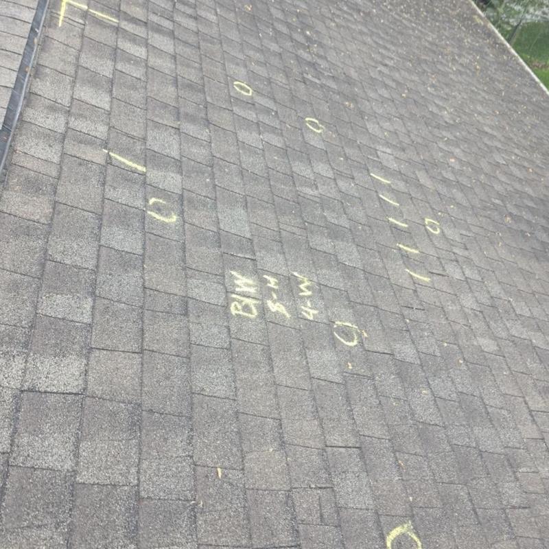 Asphalt shingle roof with hail damage markings
