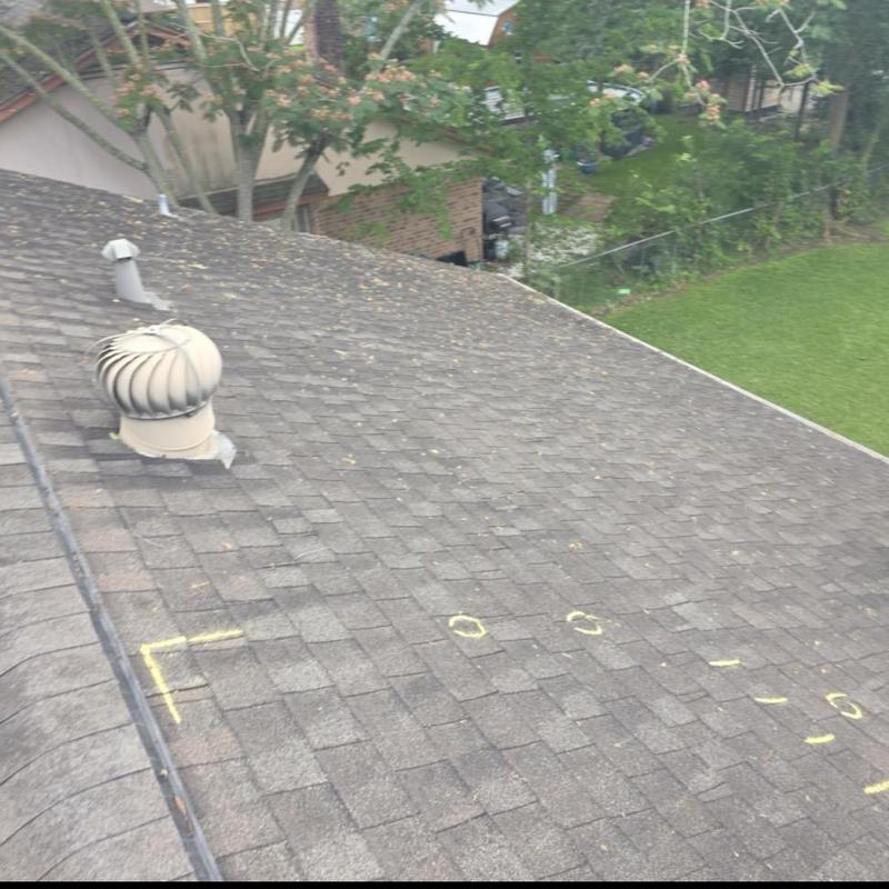 Roof shingles with hail damage marked in yellow