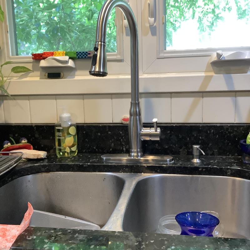 Single lever kitchen faucet installed over double sink Single lever kitchen faucet installed over double sink
