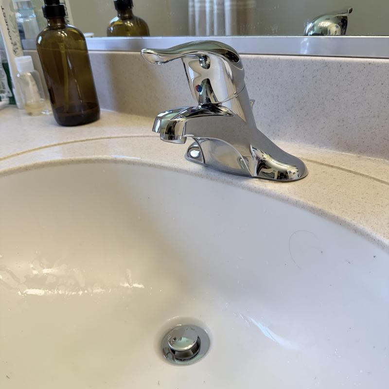 Bathroom faucet installation on white sink countertop Bathroom faucet installation on white sink countertop