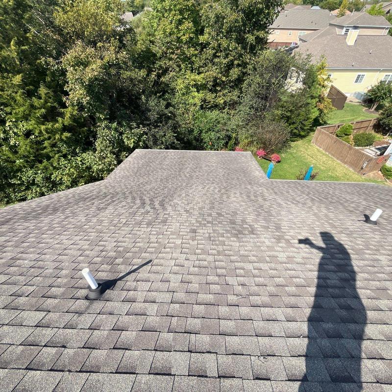 Asphalt shingle roof with vent pipe and shadow