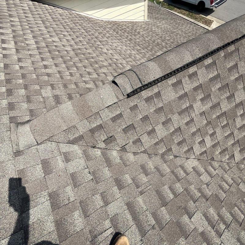 Asphalt shingle roof with ridge vent and flashing