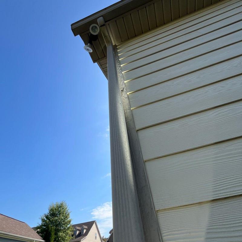 Downspout drainage system on house exterior wall