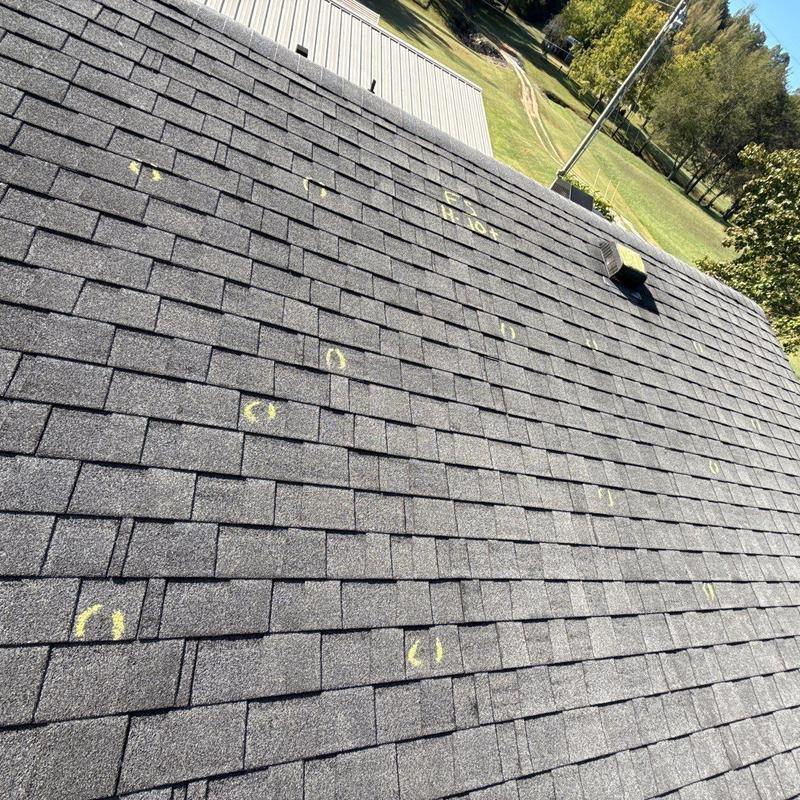 Asphalt shingles with marked hail damage on roof