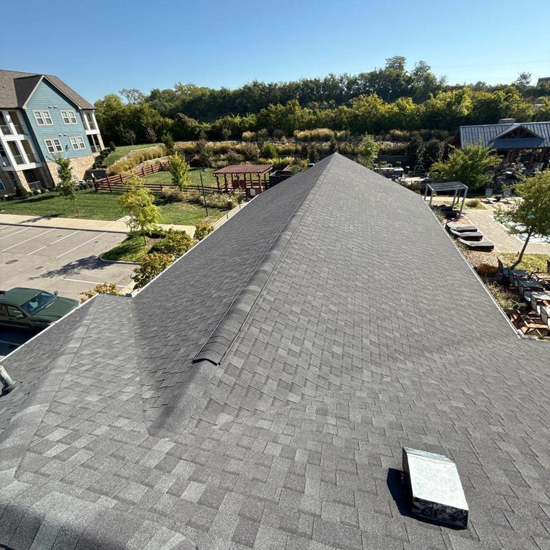 Asphalt shingle roof with ridge vent and vent pipe