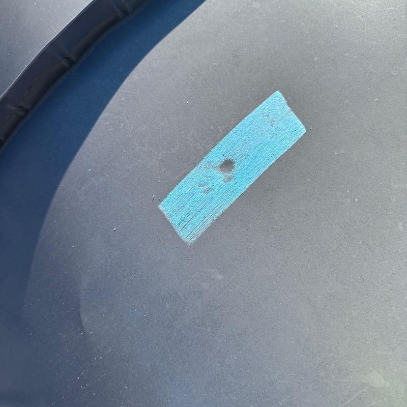 Flashing with hail damage marked by blue tape