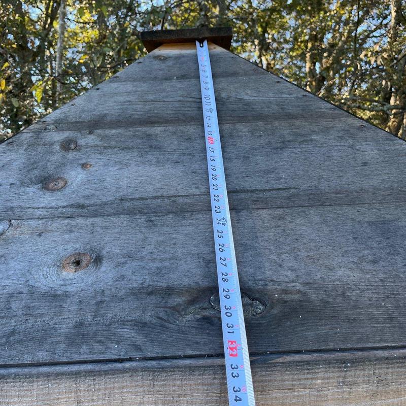 Wooden roof peak with measuring tape extended