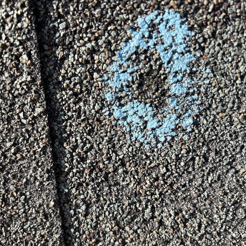 Asphalt shingles with marked hail damage close-up