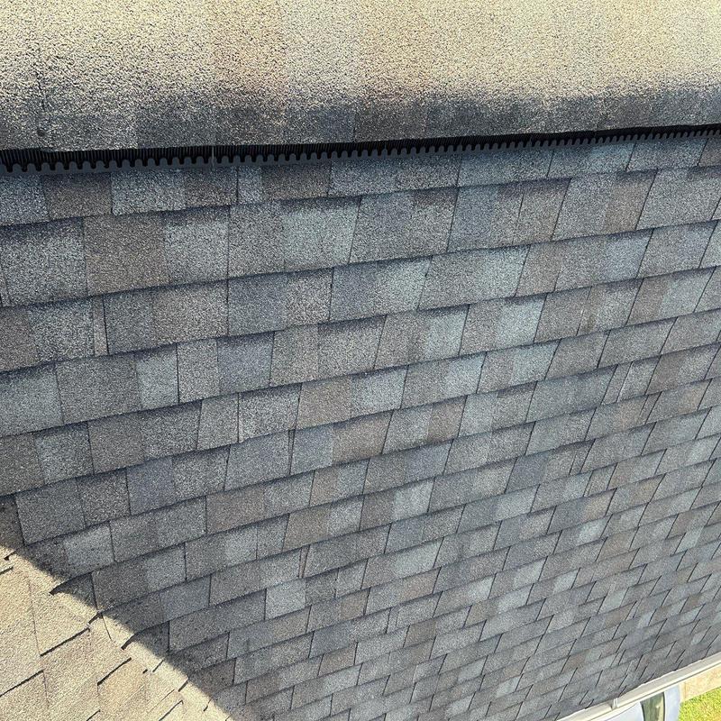 Asphalt shingles roof with hail damage and ridge caps