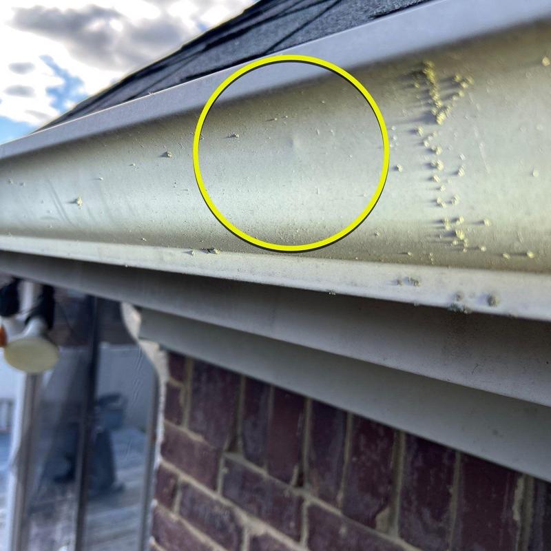 Aluminum gutter with hail damage dents