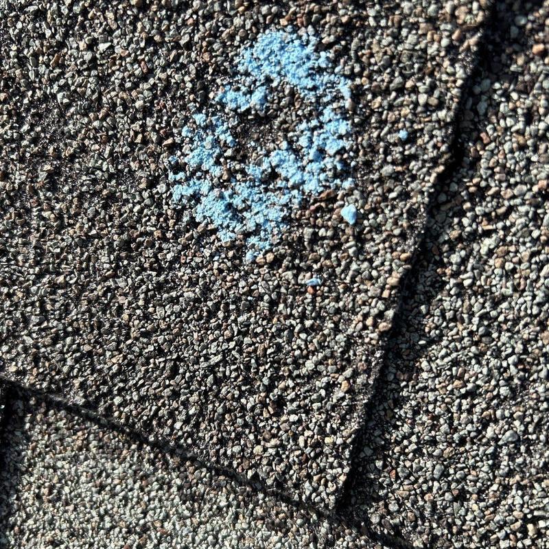 Asphalt shingles with marked hail damage close-up