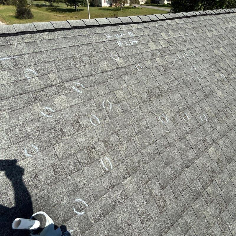Shingle roof hail damage markings on residential roof