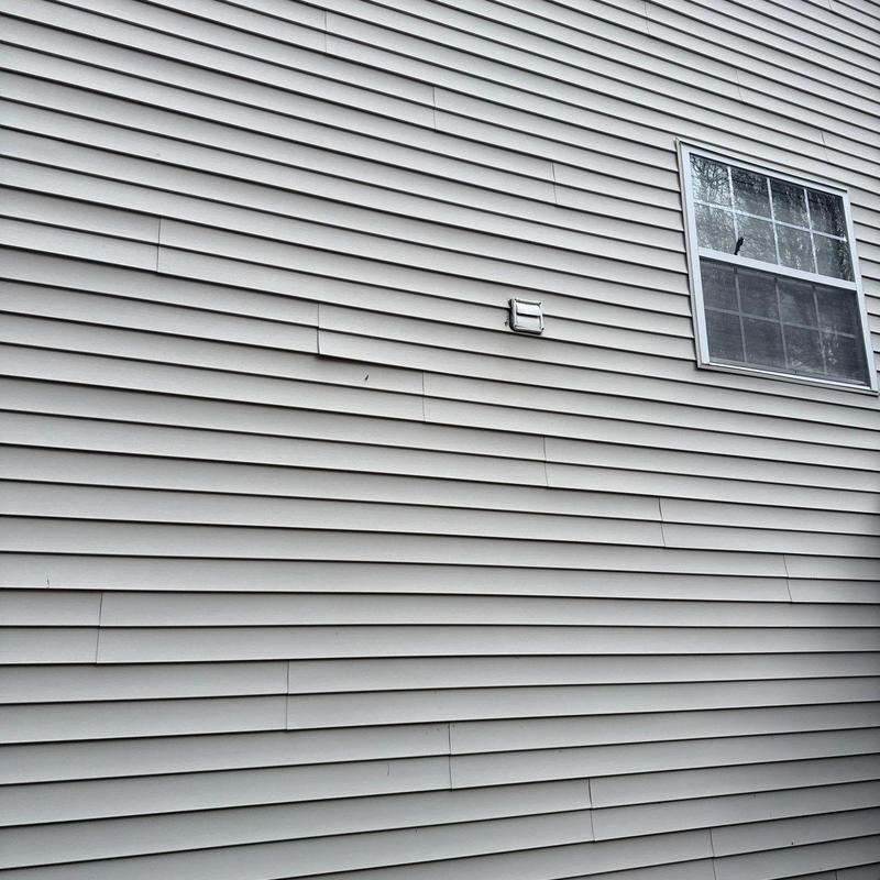 Vinyl siding panels with warping near window and vent