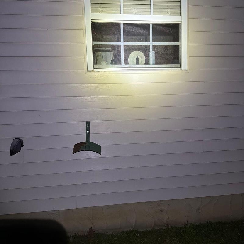 Exterior vinyl siding with mounting bracket and vent hole