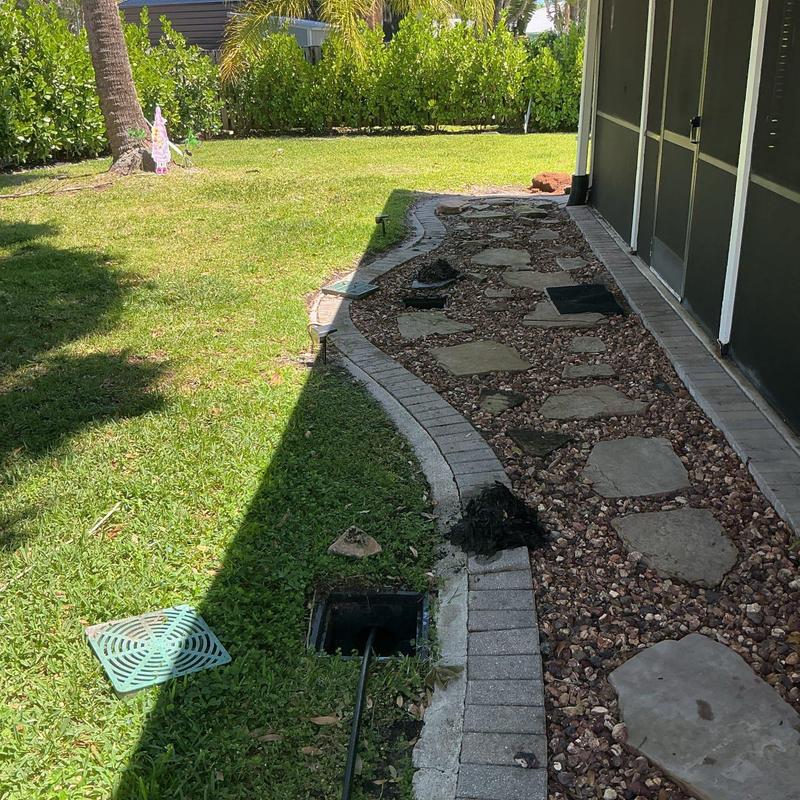 Storm drain jetting with cleaning hose in yard
