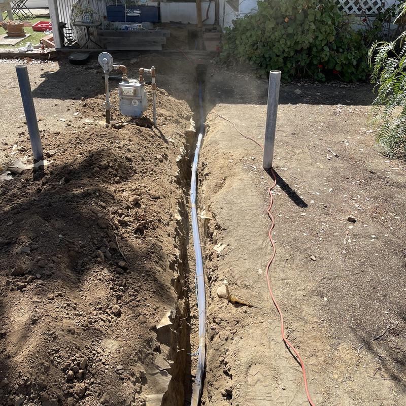 1-inch PEX water line installation in trench near meter