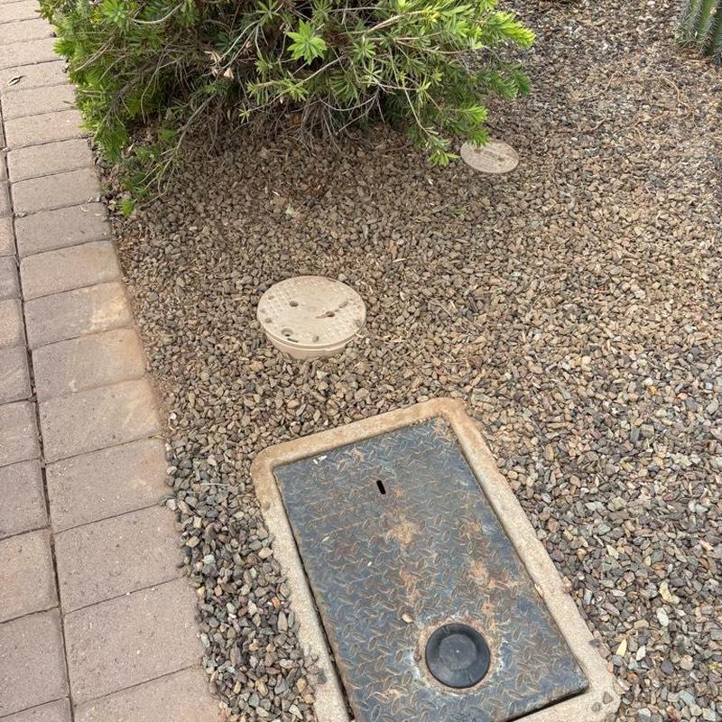 Pressure relief valve with tan access box by water meter