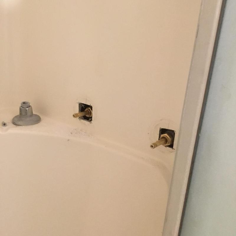 Front bathroom valve stems and wall openings in tub