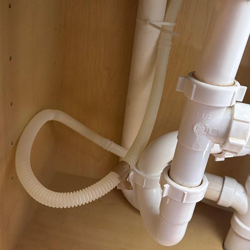 Dishwasher air gap discharge line under kitchen sink