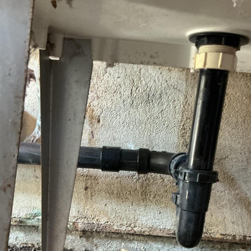 ABS sink drain pipe with fittings under sink