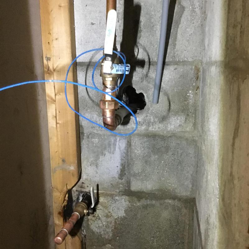 Copper water valves with isolation handles on concrete wall