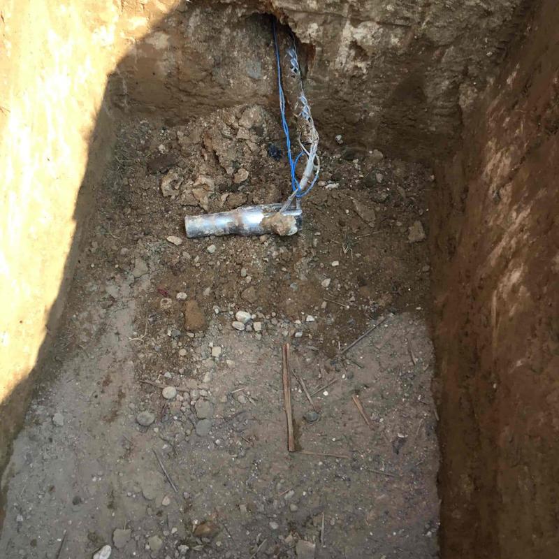 Underground water pipe and wiring in excavated hole