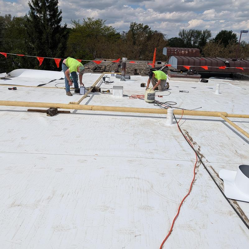 TPO single ply roof restoration with workers on roof