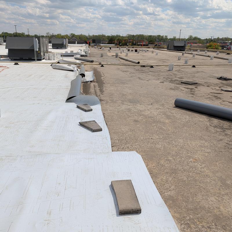 TPO single ply roof membrane being installed