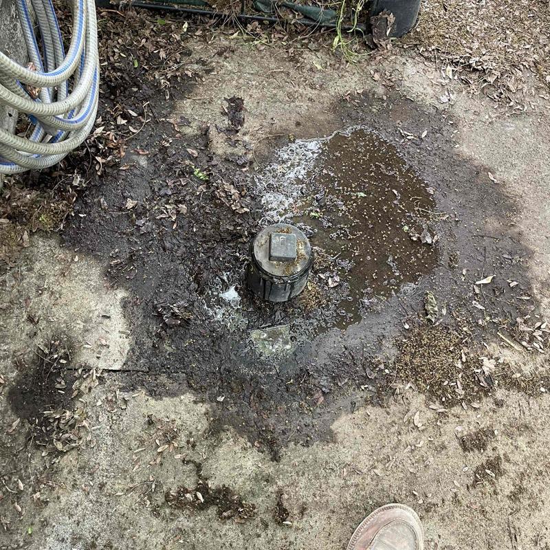 Sewer cleanout with standing sewage and water spill