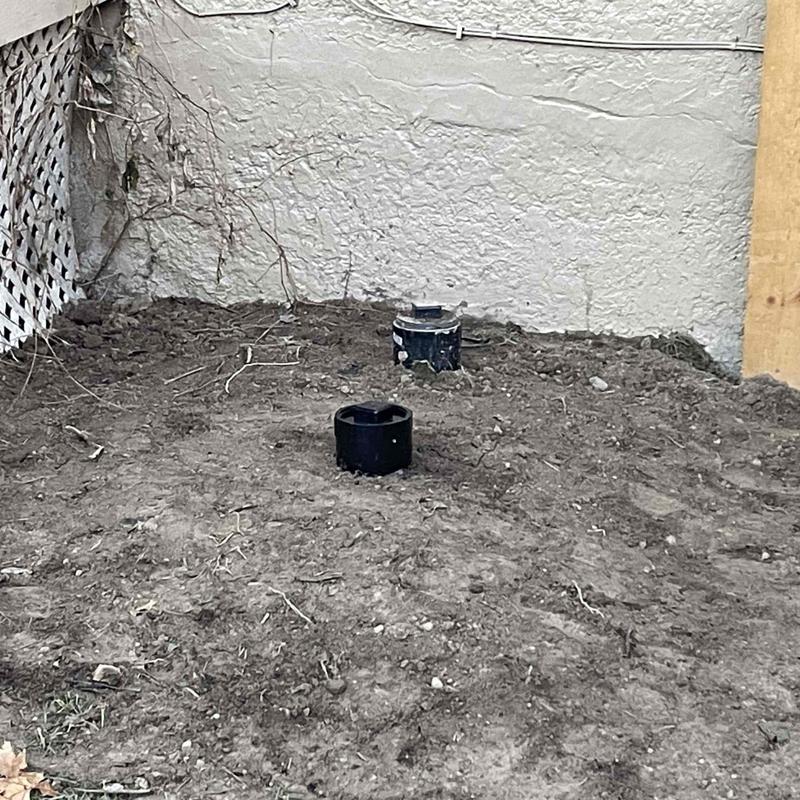 Main sewer line cleanout pipes in backyard excavation site