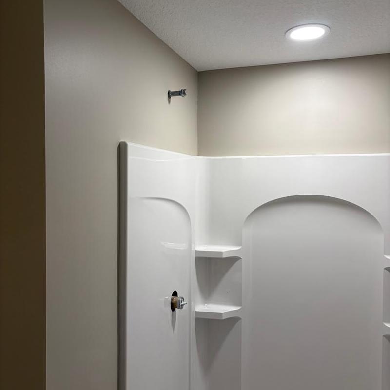 Bathroom shower stall with recessed lighting installation