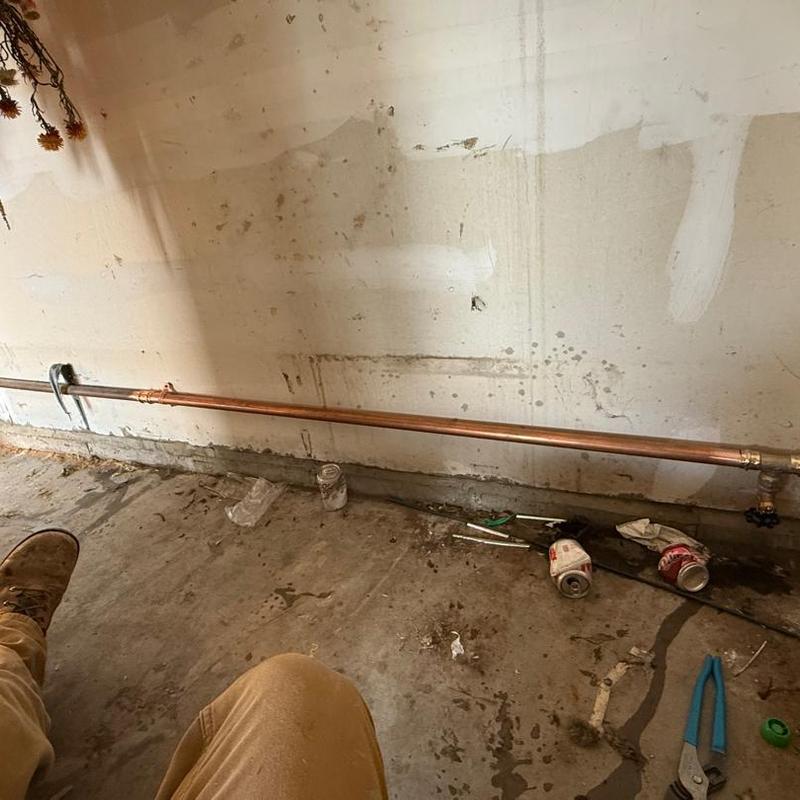 Copper water pipe with ball valve in basement