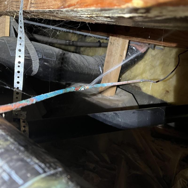 Corroded copper water supply pipe leaking in crawlspace